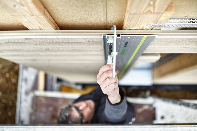 Man securing a fastening clamp