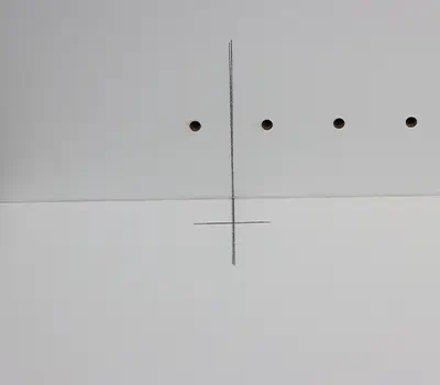 Drilling the cupboard hinge into the front of the door