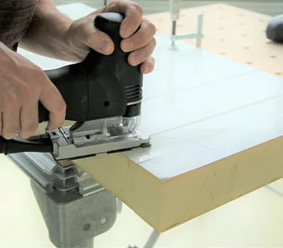 Saw the notch/radius in the composite panels at a moderate feed rate