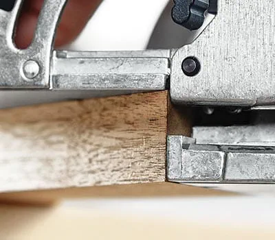 For the second routed hole, either mark out the position or run the machine flush along the outside tip of the mitre