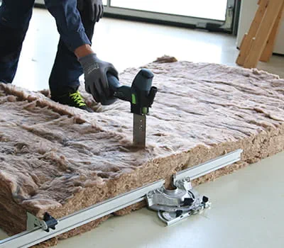 Cutting insulation between rafters for pipe openings