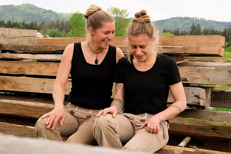 Two carpenters examining wood for the next project