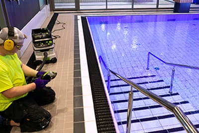 Festool TG 130 surface-restoration grinder while working on the swimming pool