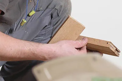 Jarek checks the tongues inserted into the grooves of the blocks by hand.